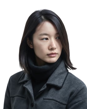 A young Asian woman with shoulder-length black hair wears a grey coat over a black turtleneck. She looks thoughtful. on white background photo
