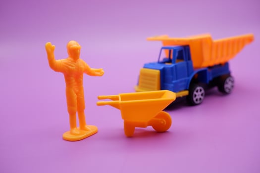 Mini Figures and Toy Trucks Displayed on Purple Background photo