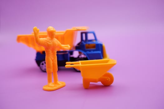 Creative Toy Trucks and Wheelbarrows Scene on Purple Background photo
