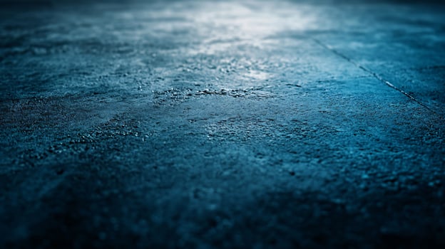 A blue and grey floor with a wet spot photo