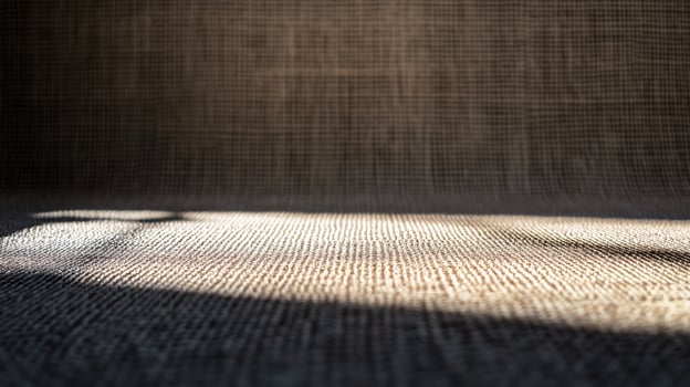Close up of a patterned carpet with a shadow cast on it. The shadow is dark and the carpet is light photo