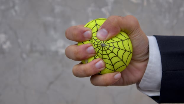 Close-Up of a Hand Squeezing a Stress Ball with Web Design photo