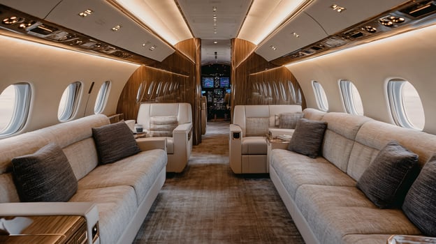 Large airplane with a spacious interior and many couches. The couches are white and the room is well lit photo