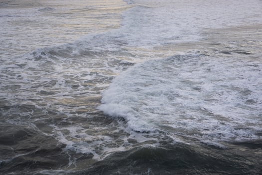 Rolling Waves with White Foam Creating Intricate Patterns on the Sea Surface photo