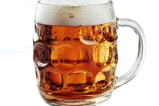 Large beer mug full of refreshing amber lager with foam head photo