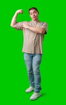 A man flexes his muscles playfully against a vibrant green background photo