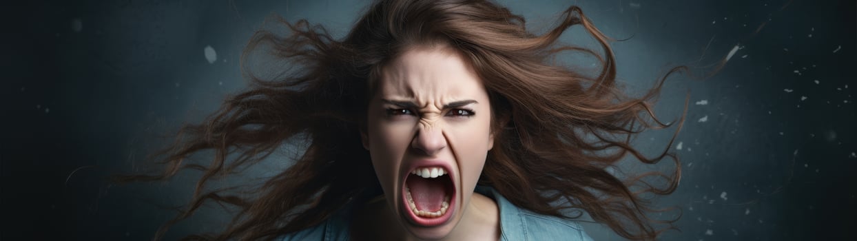 Angry young woman screaming with windblown hair photo