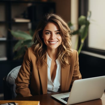 smiling young woman working on laptop in cozy office photo