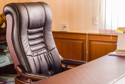 Luxurious upholstered chairs and desks for boss in office photo