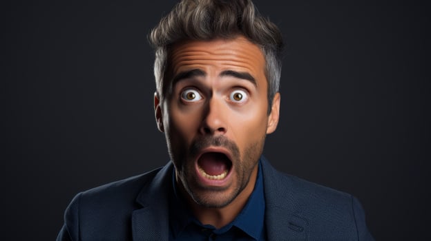 Shocked businessman with wide open eyes photo