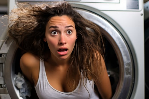 surprised woman with messy hair in washing machine photo