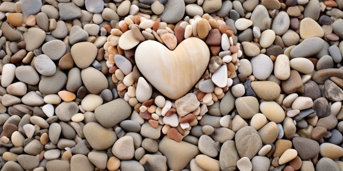 Heart shaped stone surrounded by pebbles photo