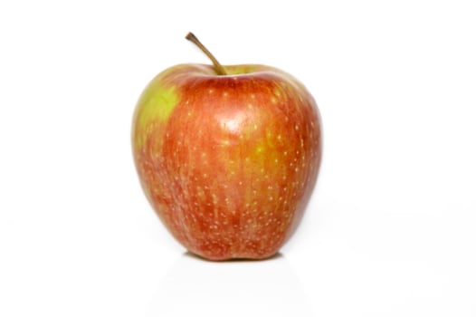 Bright red apple resting on a white background showcasing vibrant colors and natural shine photo