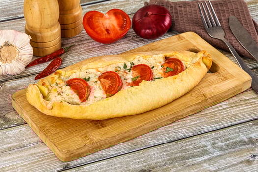 Turkish Pide with cheese and tomato photo