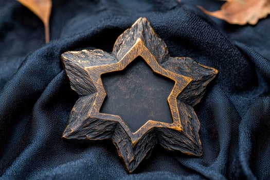 A star shaped brooch on a dark cloth photo