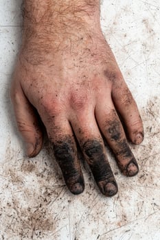 Dirty hands of a worker after a hard days labor photo
