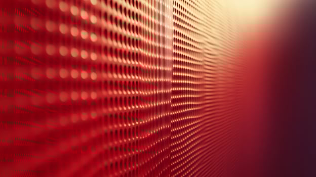 A red wall with a pattern of holes photo