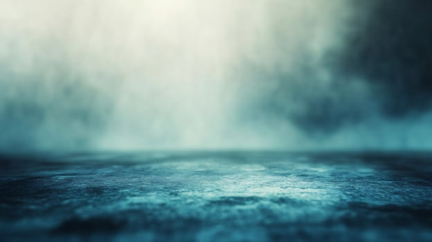 A blurry image of a wet road with a misty sky in the background photo