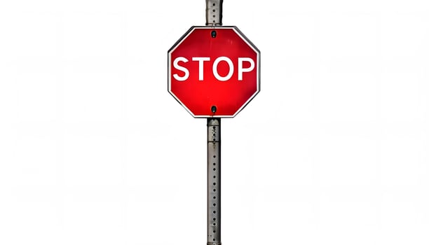 A stop sign on a pole with a white background photo