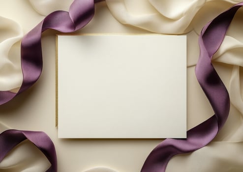Elegant blank invitation card surrounded by luxurious ribbons on a soft background photo