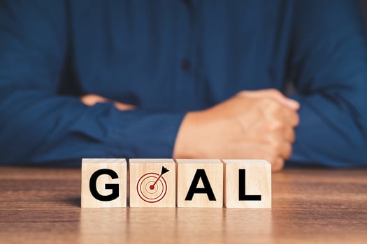 Business achievement concept. Wooden cubes with GOAL word on a wooden desk photo
