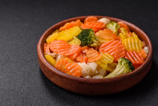 Delicious fresh vegetables steamed carrots, broccoli, cauliflower photo