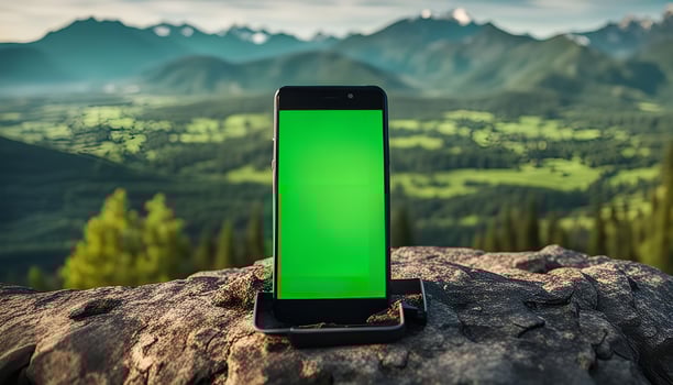 Smartphone on Mountain Peak with Green Screen photo