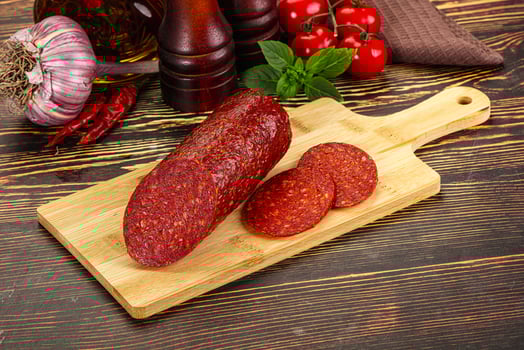 Spicy pepperoni sausages with sliced piece photo