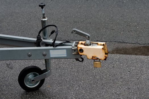 Front section of a trailer hitch on a paved surface. photo