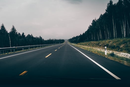 car driving on the asphalt road, dark background. photo