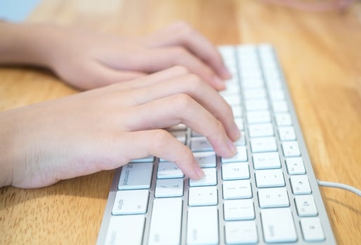 The girl is typing the keyboard photo
