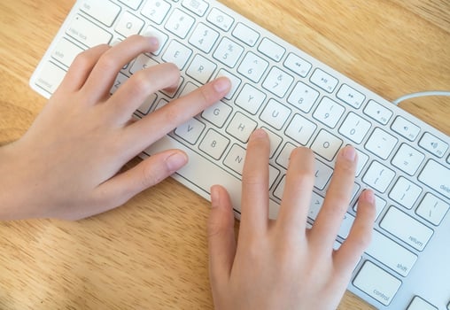 The girl is typing the keyboard photo