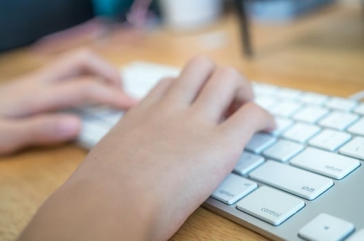 The girl is typing the keyboard photo