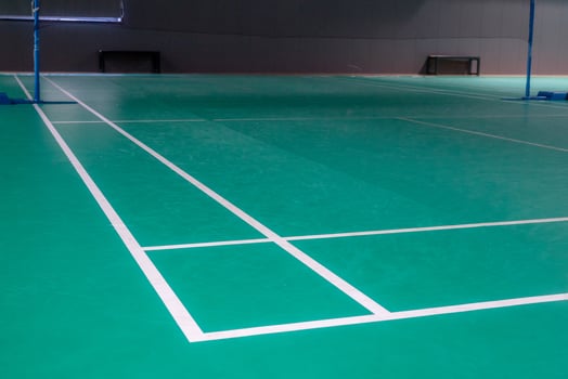 Empty green badminton court for playing photo
