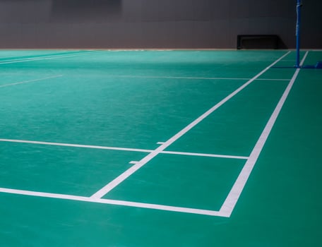 Empty green badminton court for playing photo