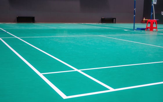 Empty green badminton court for playing photo