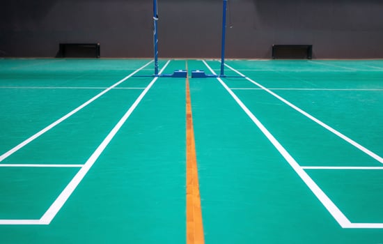 Empty green badminton court for playing photo