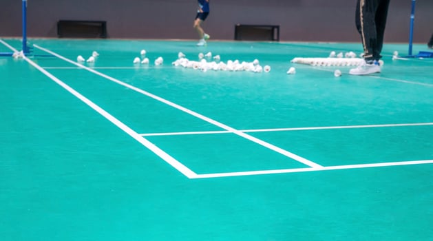 teacher are teaching student in the badminton court photo