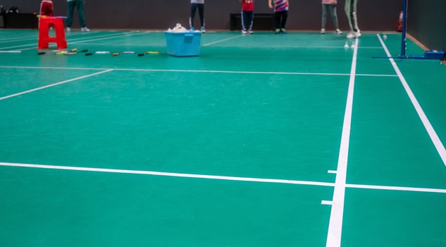 Empty green badminton court for playing photo