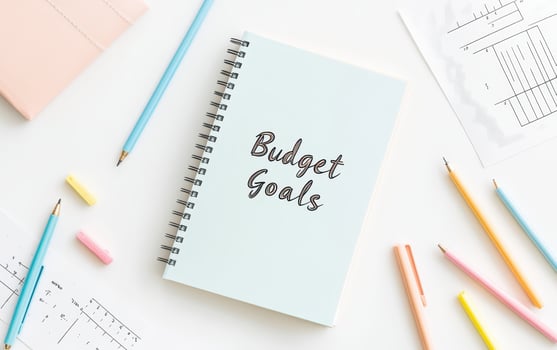 Budget Goals journal on clean workspace with colorful stationery, inspiring organization and planning photo