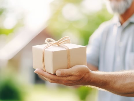 Delivery person handing package with care, showcasing warm gesture. scene captures essence of thoughtful service and connection photo