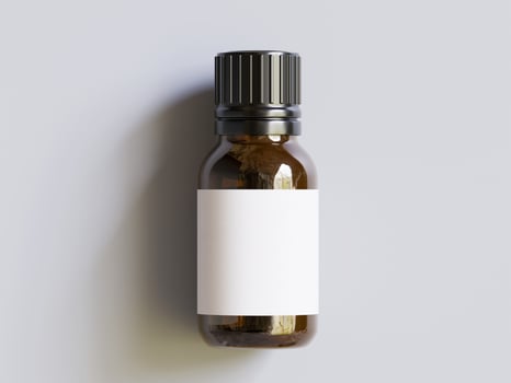 A bottle of essential oil with a blank label photo