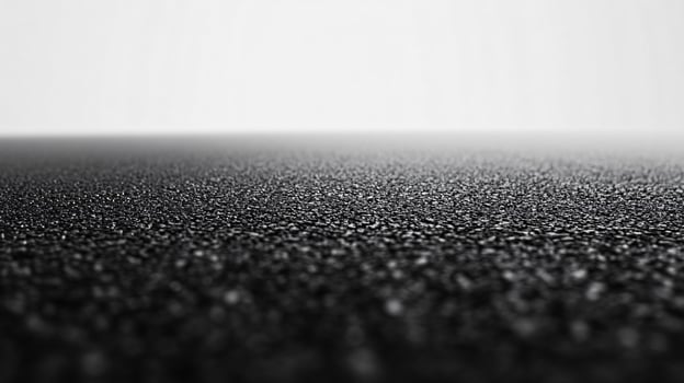 A black and white photo of a road with a white background