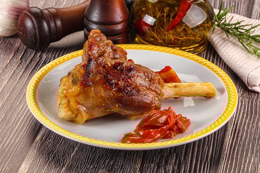 Baked lamb shank with vegetables photo