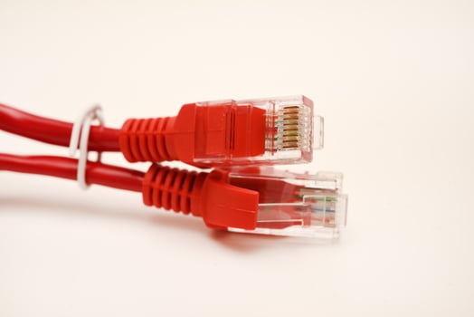 Red internet cable on a white background. The RJ-45 connector. photo