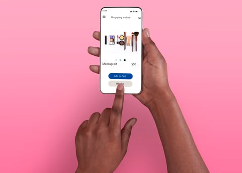 Female Shopping Concept. Above top overhead view of black woman browsing online make up store on her smart phone, isolated on pink background, touching screen. Customer ordering via internet photo
