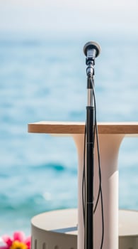 black microphone on a wooden table by the sea photo