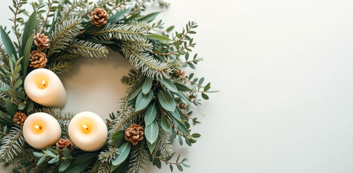 scented evergreen wreath with lit candles photo