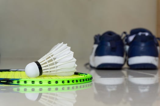 Set of badminton equipment with rackets, shoe, and shuttlecocks photo