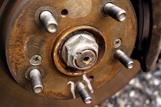 Close up of lock nut of front axle shaft in the vehicle engine powertrain system , Automotive parts concept photo